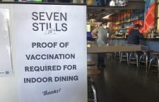 A proof of vaccination sign is posted at a bar in San Francisco on Thursday, July 29, 2021. Until now, many employers had taken a passive approach to their unvaccinated workers, relying outreach and incentives. But that has been shifting, with vaccine mandates gaining momentum. (AP Photo/Haven Daley)